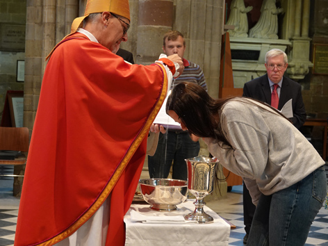 Candidate being baptised by Bishop Martin