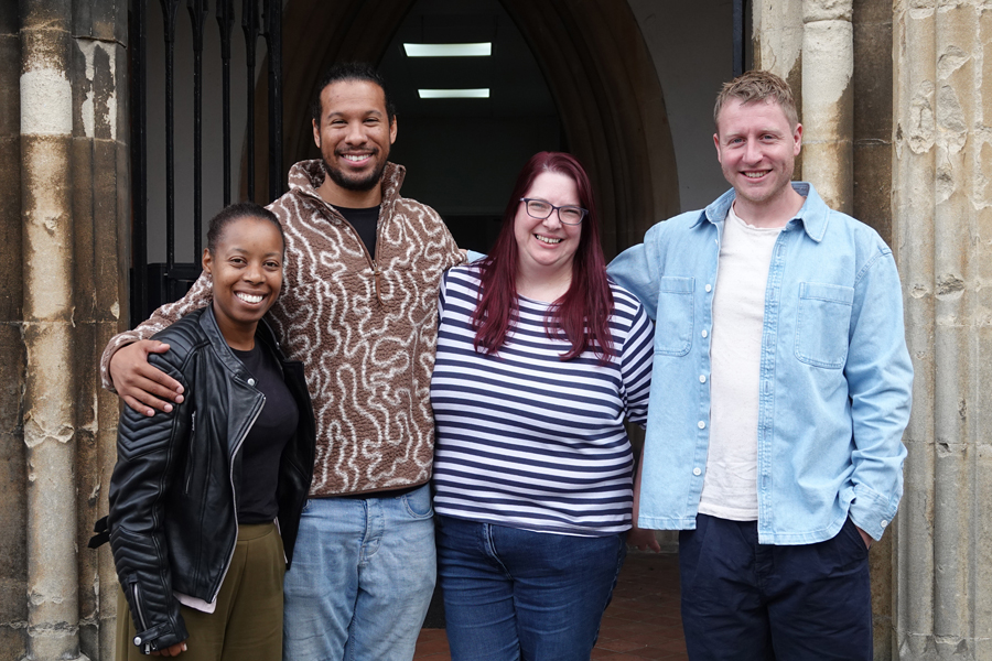 Some of the team at St Stephen's Church standing with their arms around each other in the church doorway