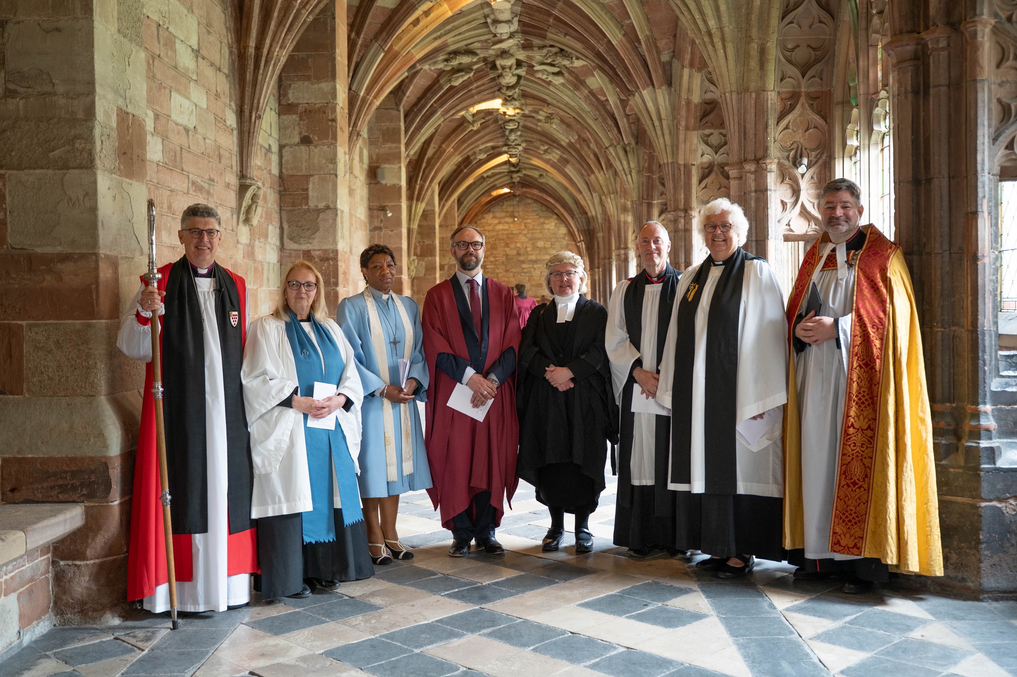 Honorary Canons standing in the Cloister with Bishop Martin & the Dean