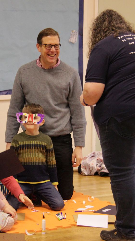 Helen talks to a family taking part in Early Birds New Worshipping Community