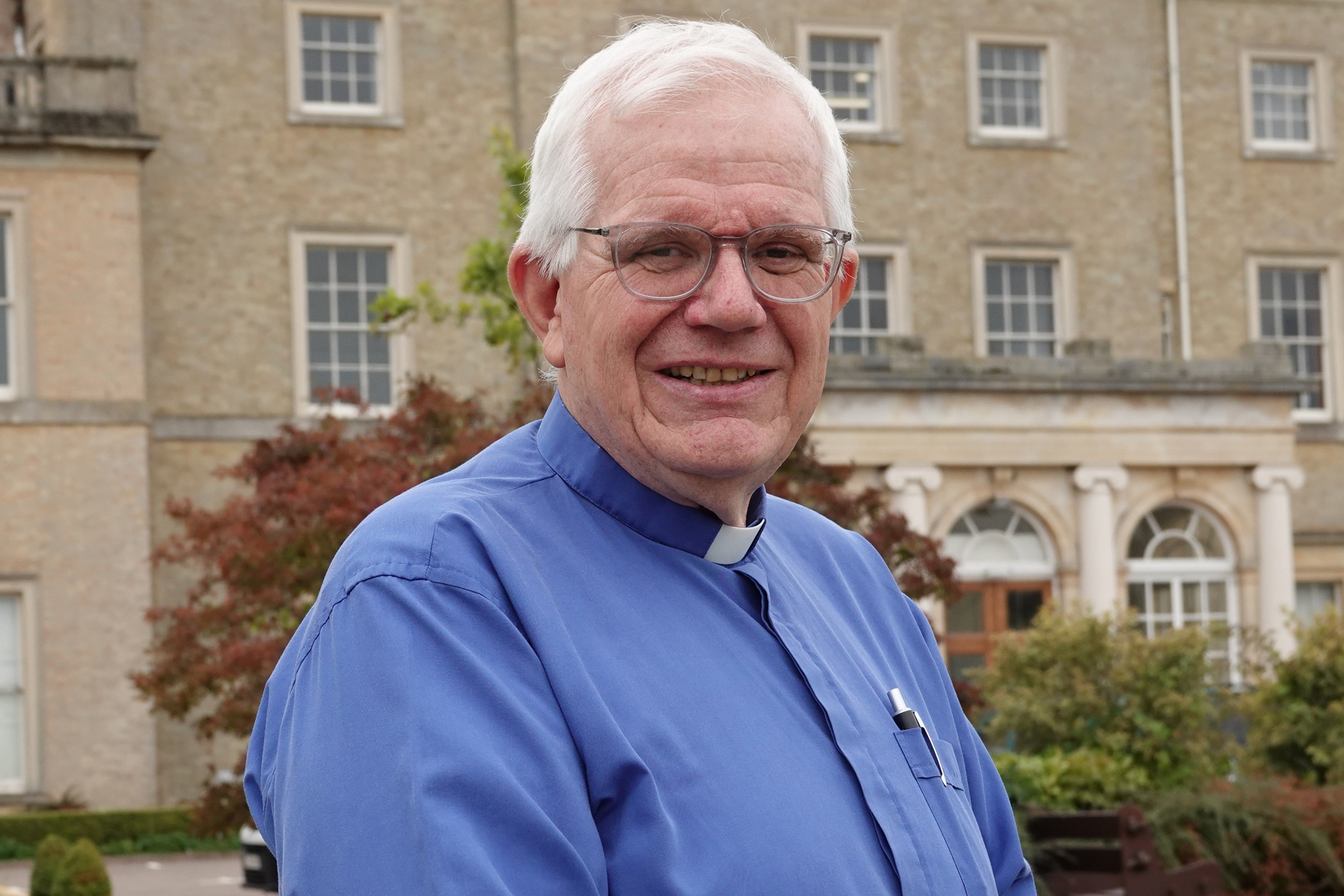 Dick Johnson standing in front of a grand house which is the Police Headquarters in Worcester