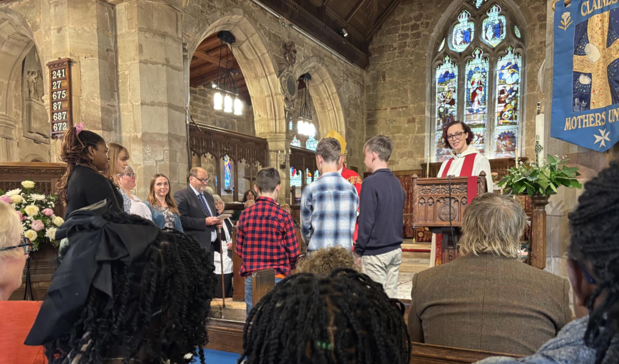 Confirmation candidates standing around Bishop Alan at the front of Claines church