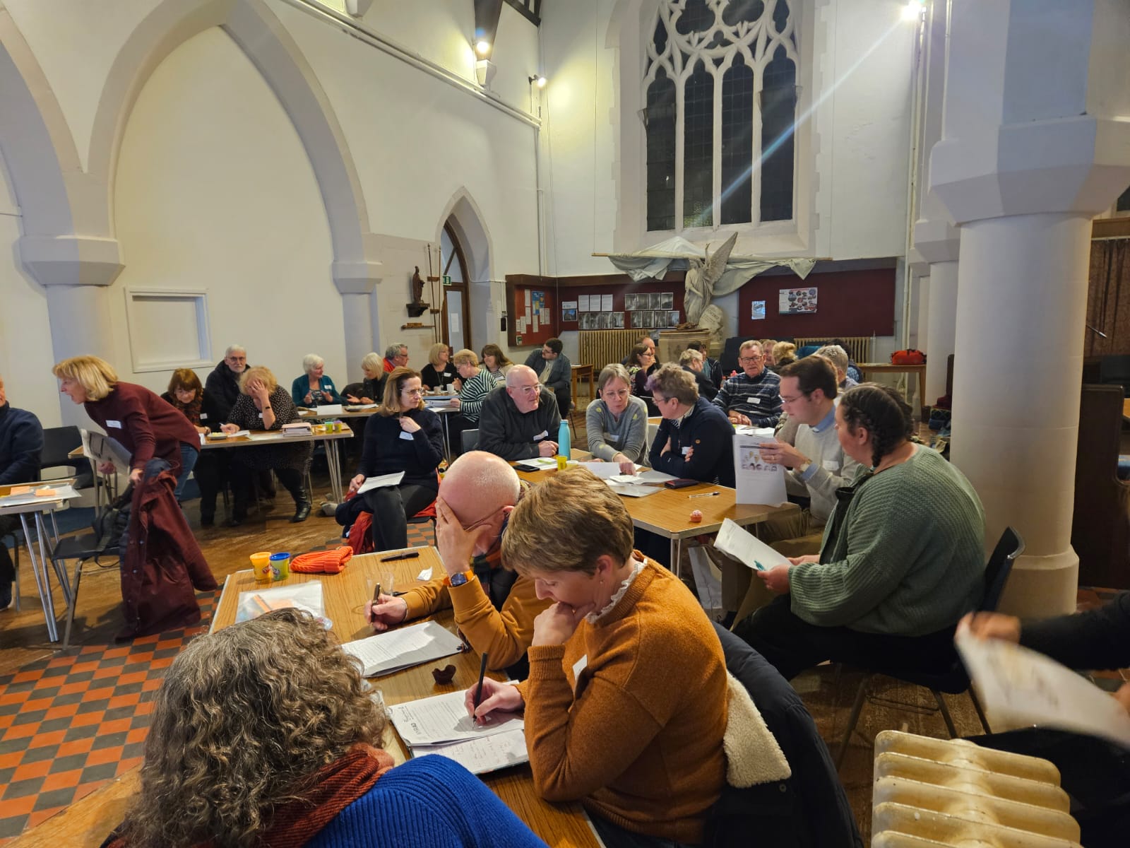 Groups of people at the learning community sat around tables