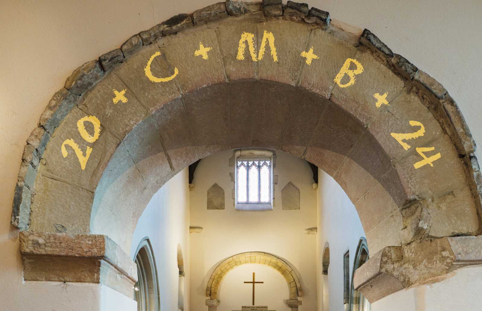 Chalk blessing on an arch inside of a church for Epiphany