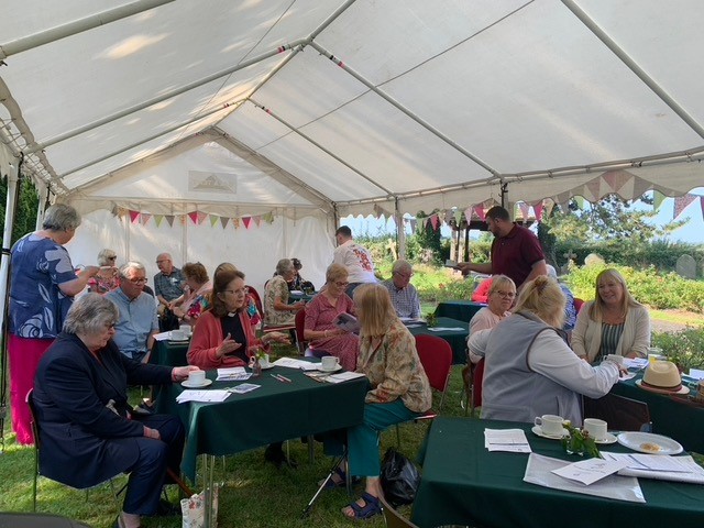 People sitting inside at tent at the fayre