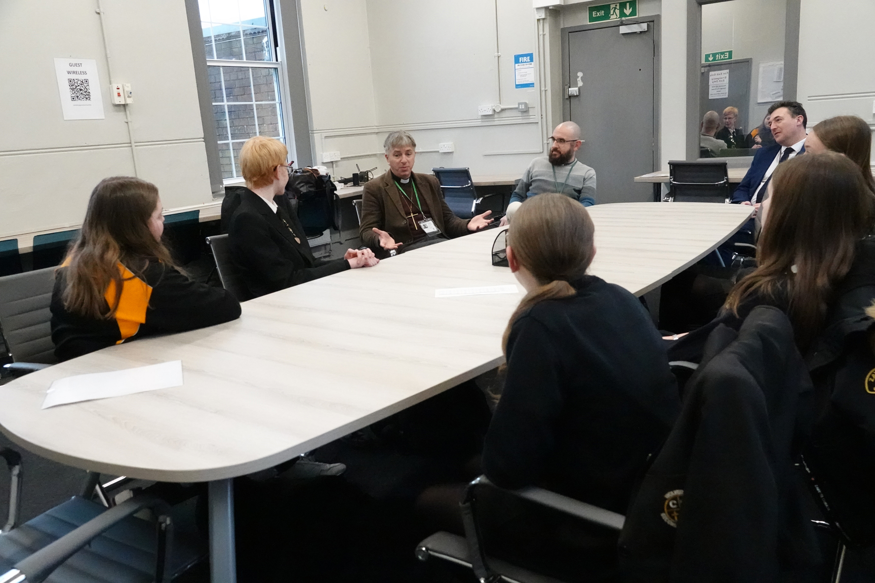 Bishop Hugh sat with students around a big table