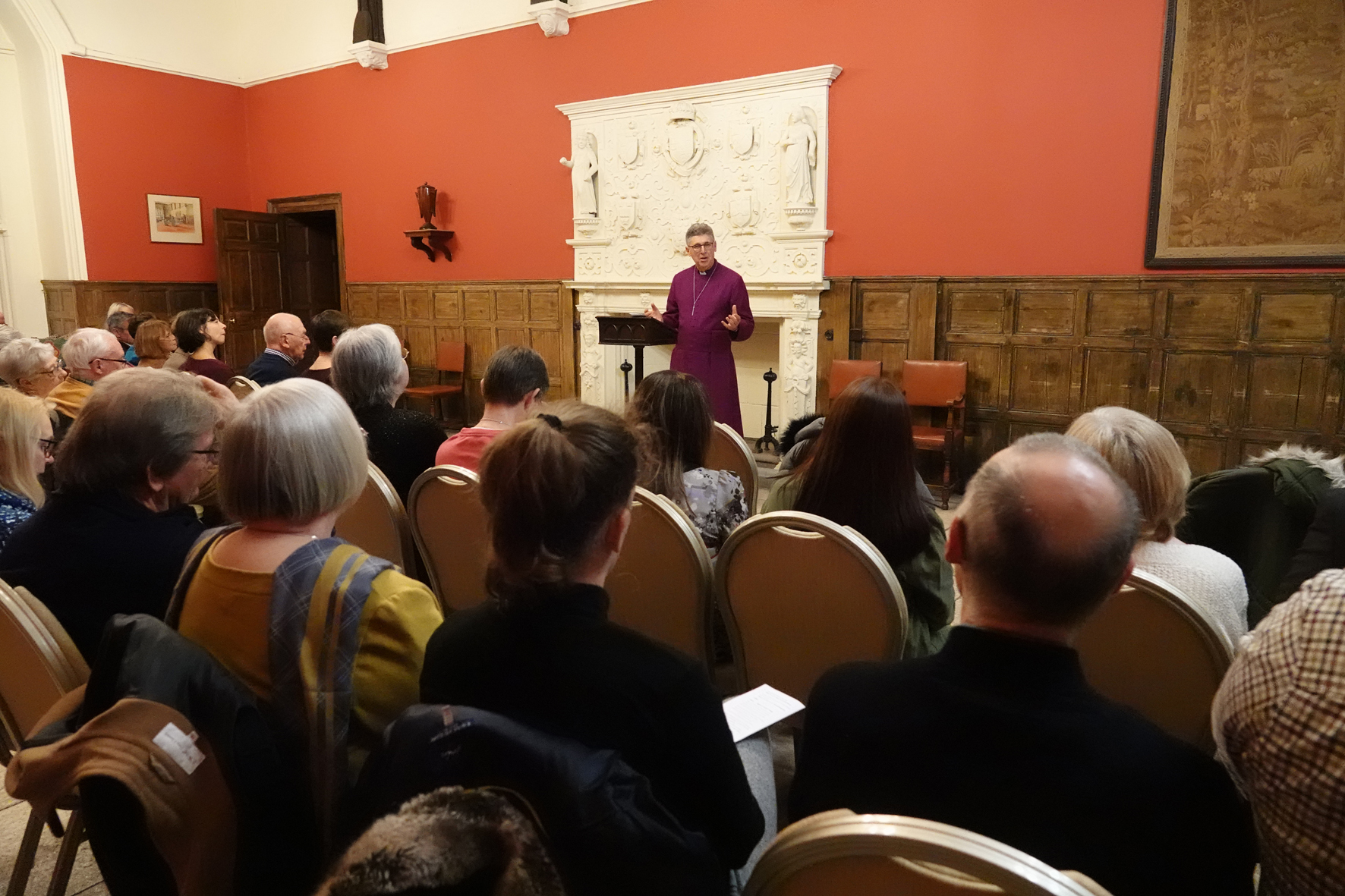 Bishop Martin standing speaking at the front of a group of people
