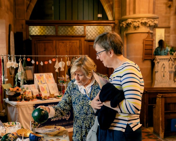 Two ladies looking at some crafts