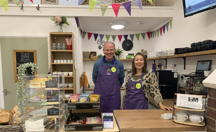 Two volunteers standing behind the counter at Clent Connect