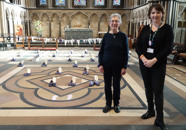 Judith Grubb and Jo Wilson standing next to the exhibition of shoes