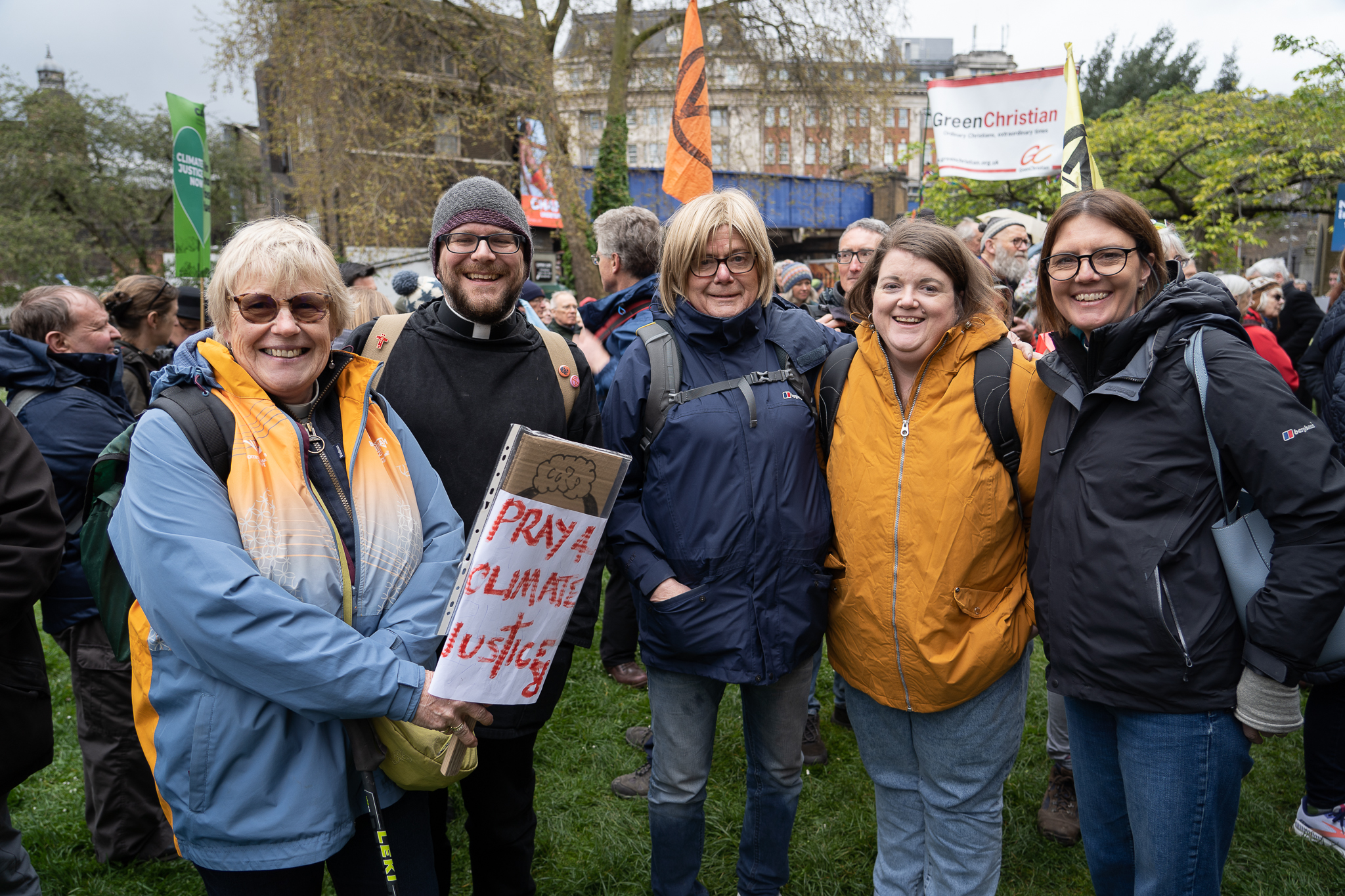 Group of people from the diocese with a 'pray for climate justice' banner