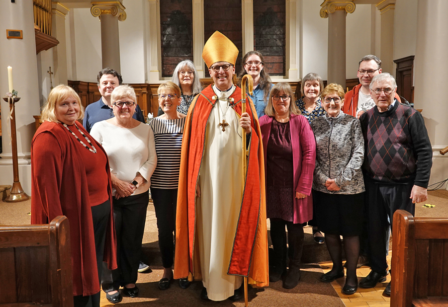 Bishop Martin surrounded by the new worship leaders