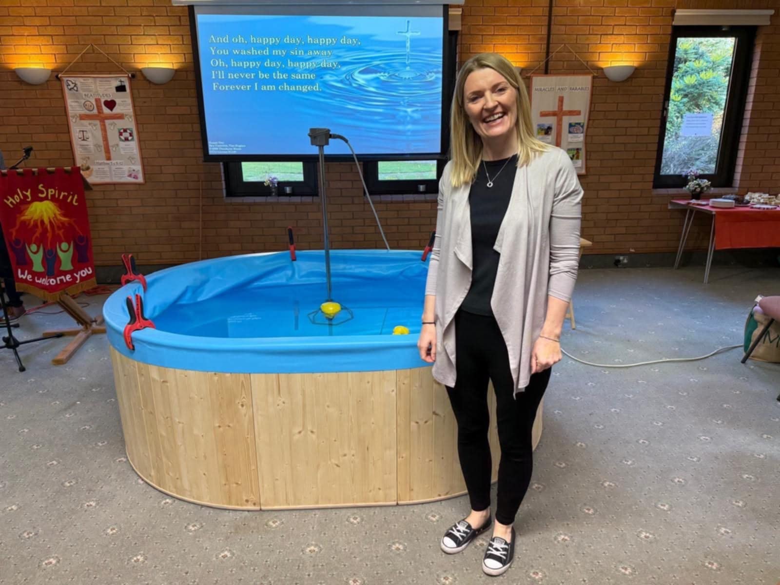 Rebecca Cambray standing next to a pool in St Peter's Ipsley ahead of her baptism