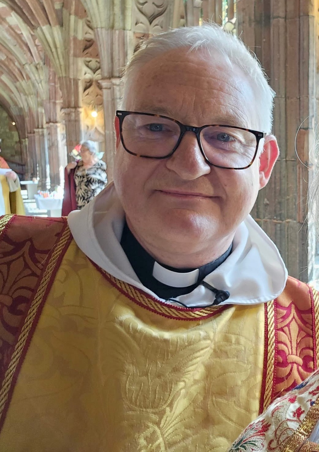 Head and shoulders shot of Mark Badger in robes in the Cathedral cloister