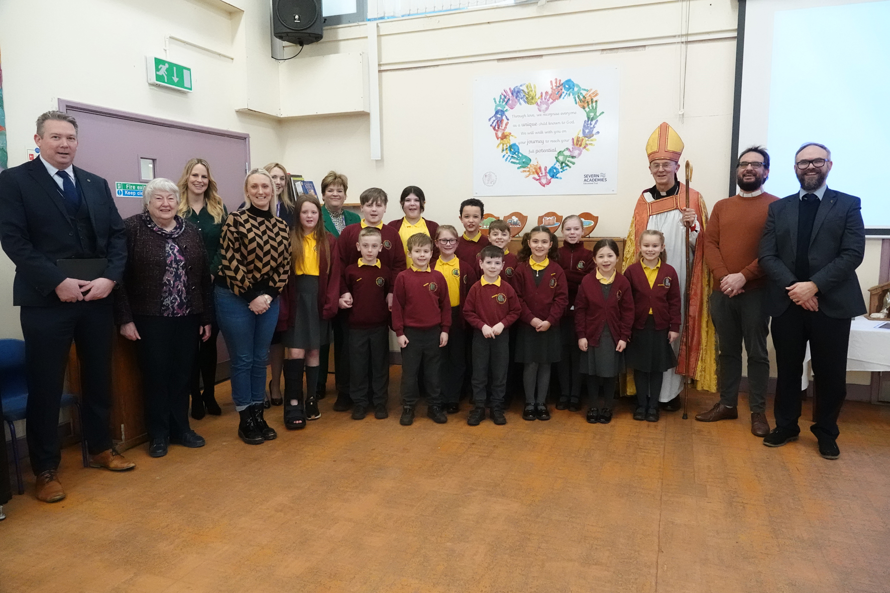 Bishop John standing with pupils and staff from Hartlebury Primary School