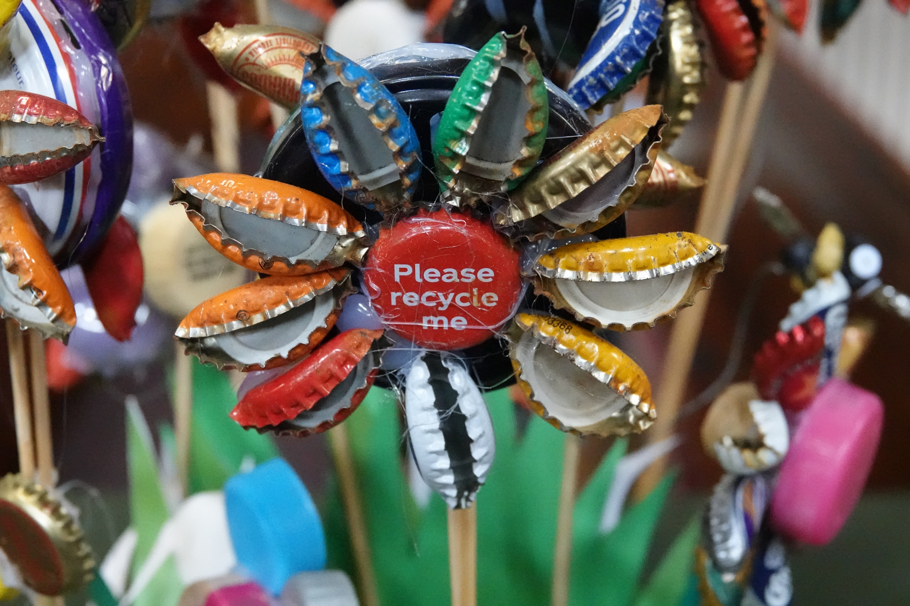 Flower created from recycled metal bottle lids