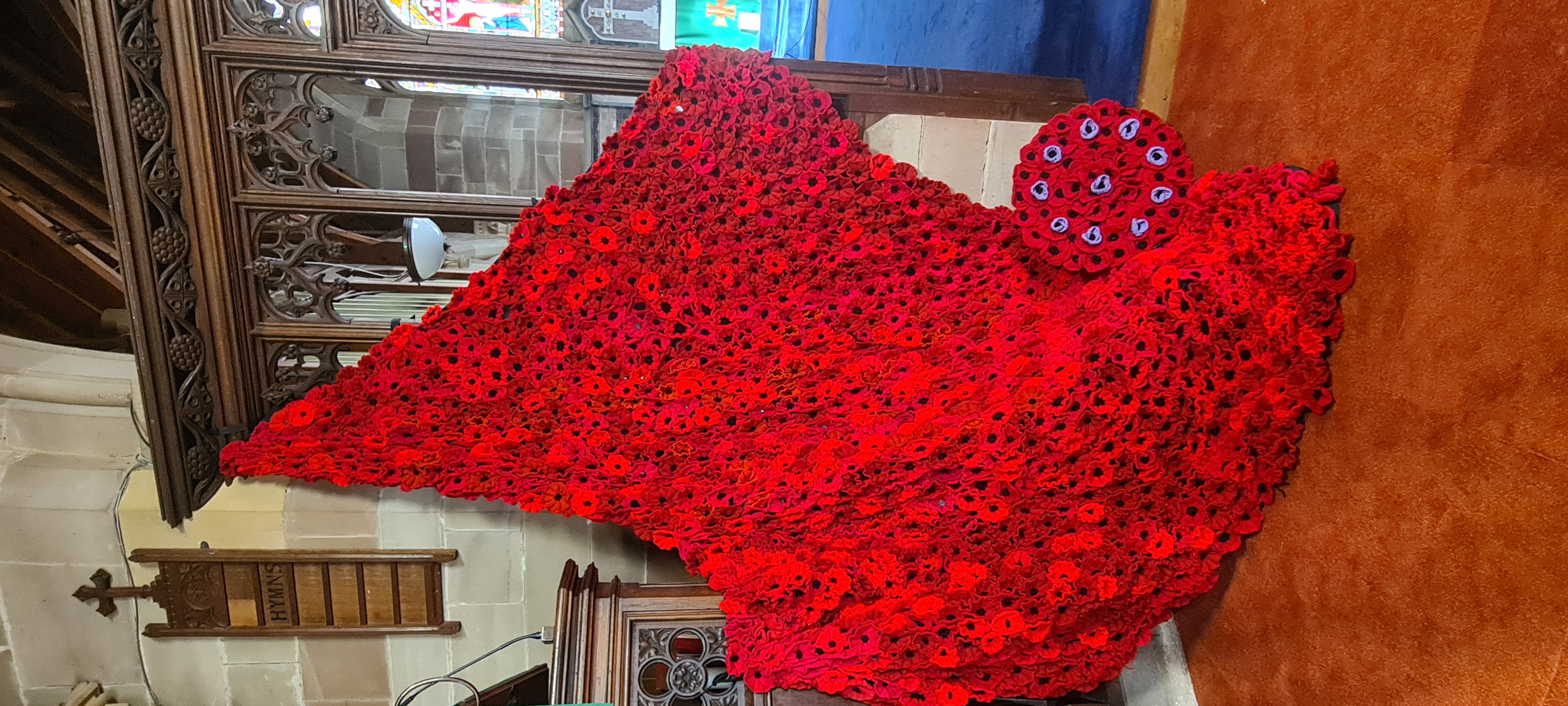 Poppies cascading from the Rood Screen over the pulpit in St Philip's Church