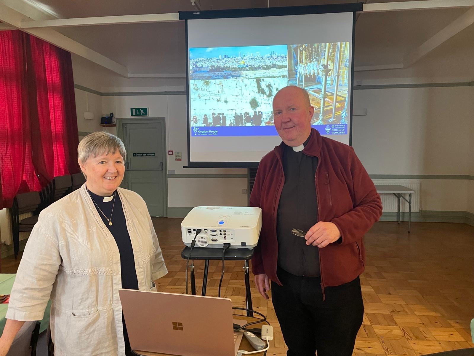 Alison Maddocks and Doug Chaplin standing in front of the presentation