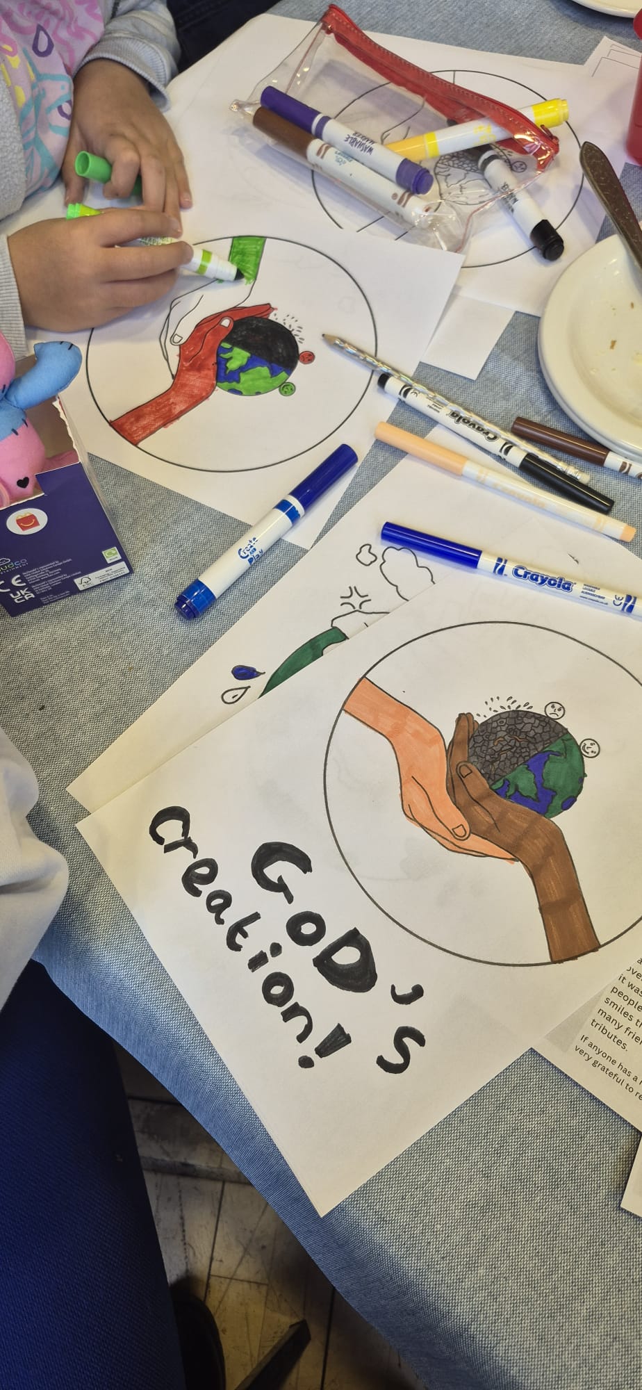 children's hands colouring in creation based pictures