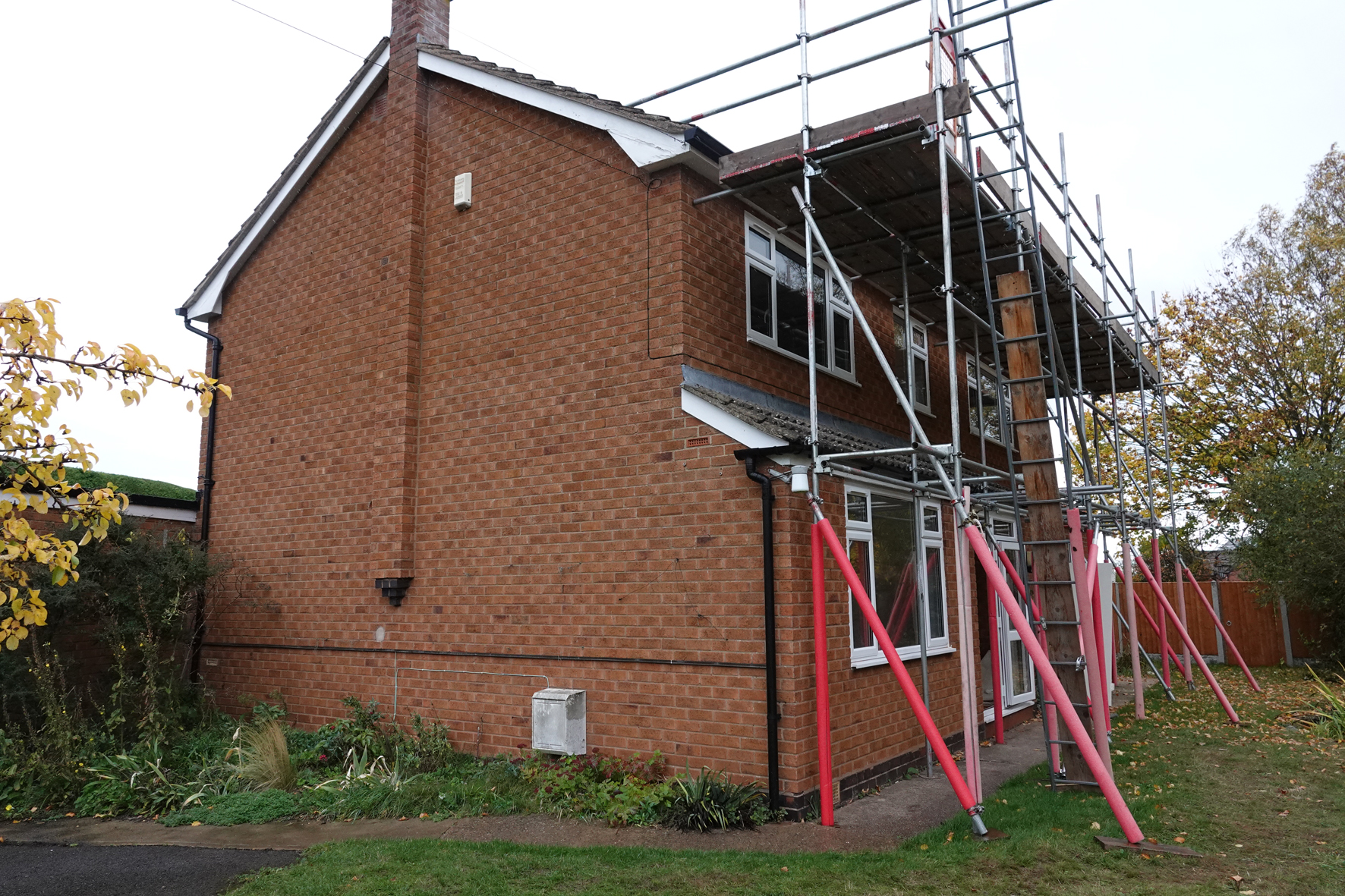 A side view of Harvington Rectory with scaffolding on the front of the house