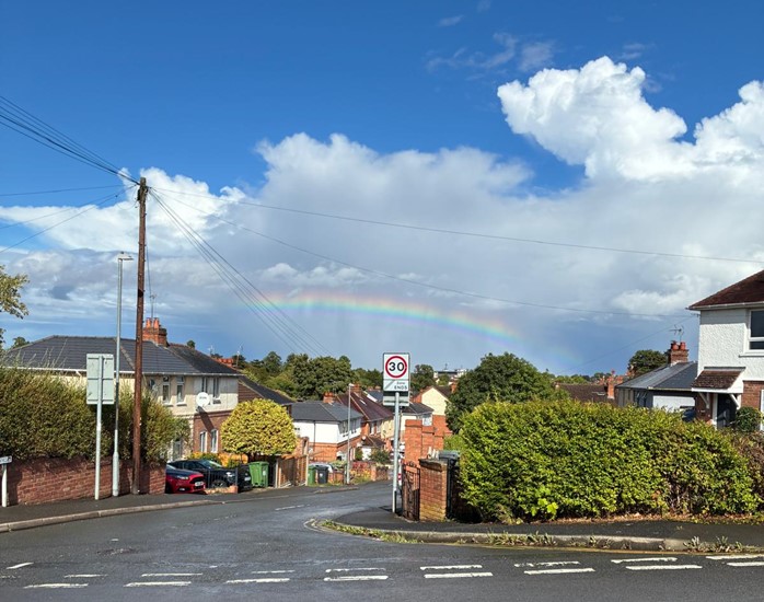 Rainbow over a residential road 