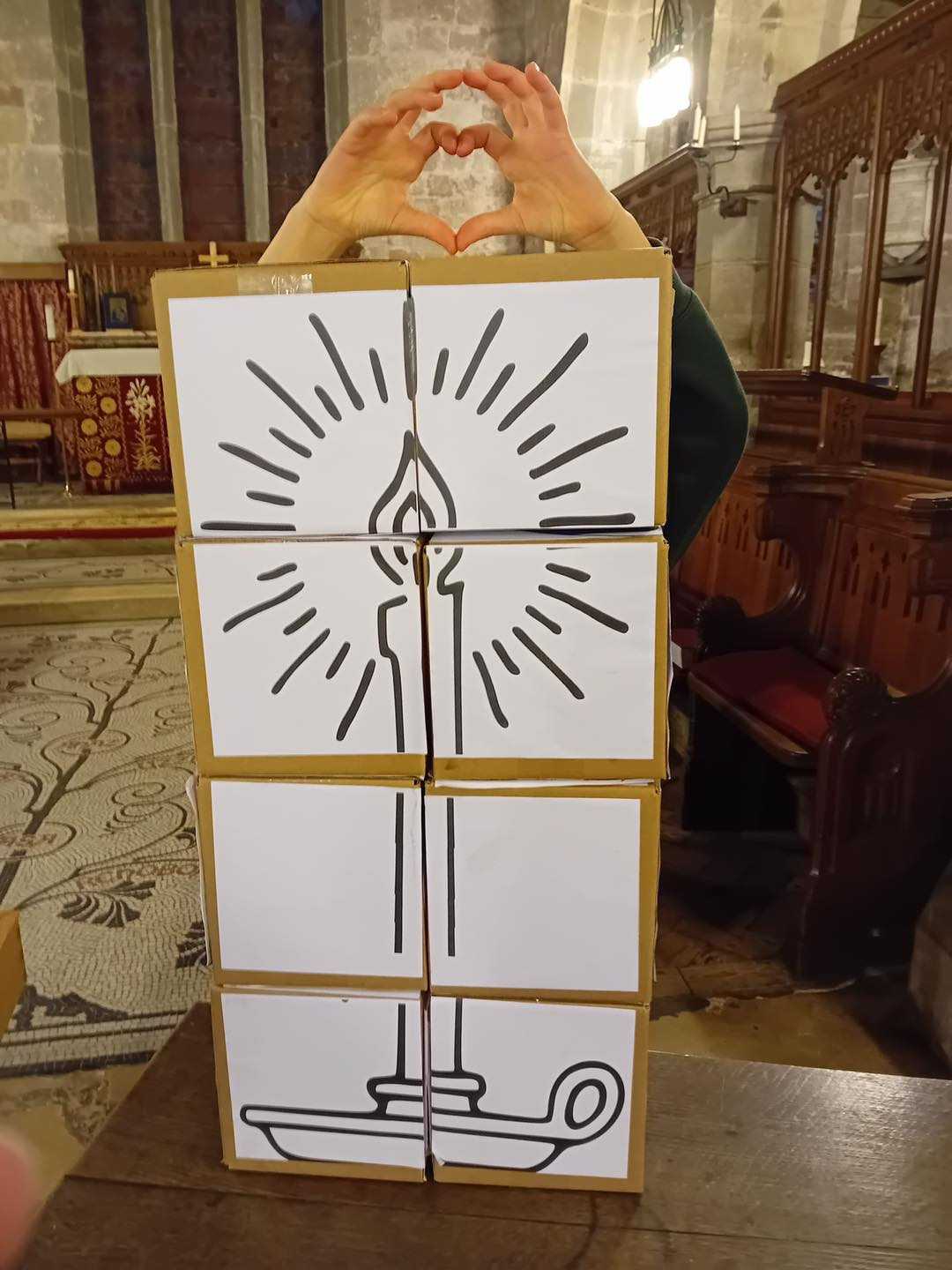 Christingles unfolding cardboard cube being used in church