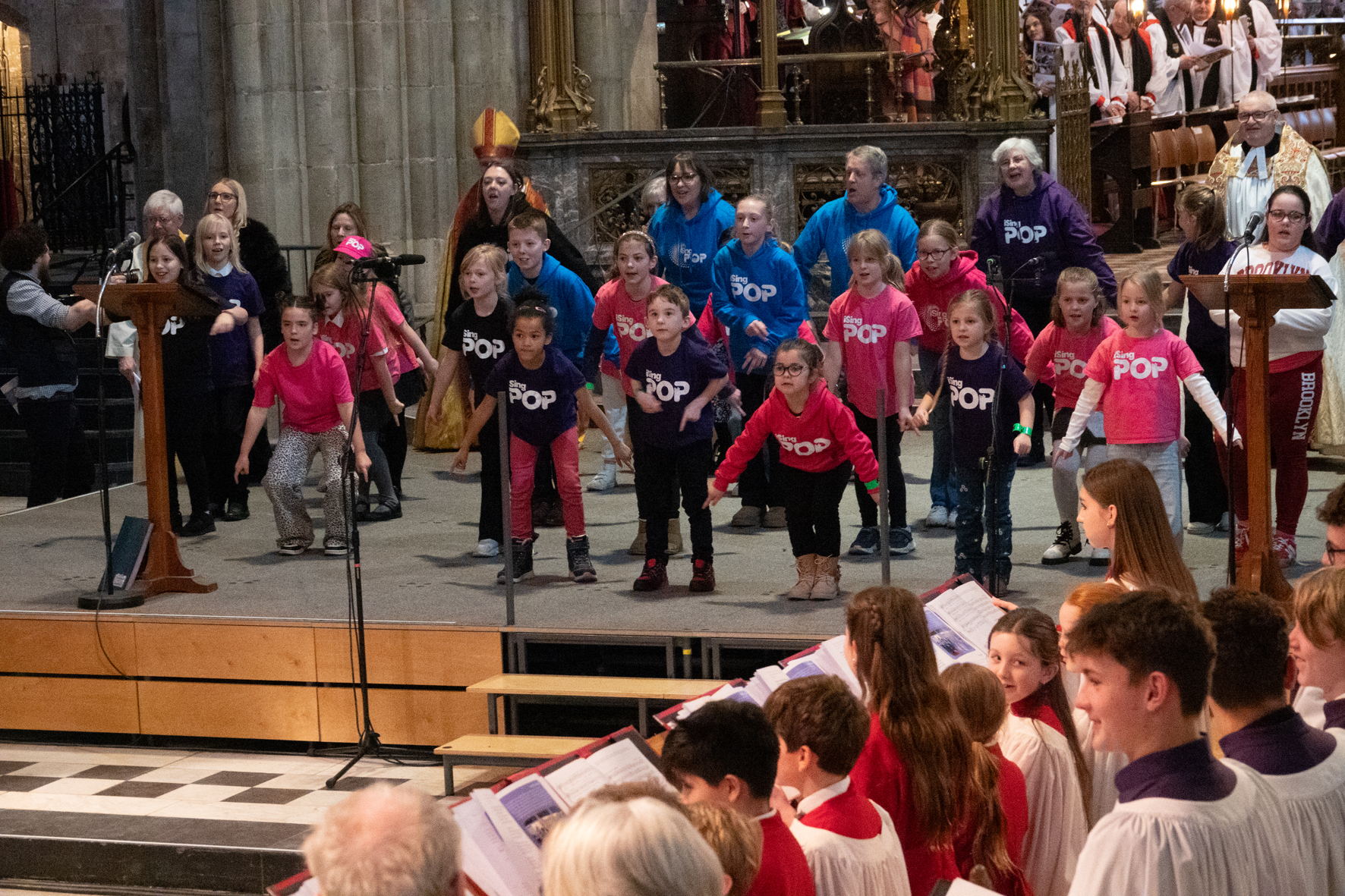 A choir from isingPop singing and dancing on the platform