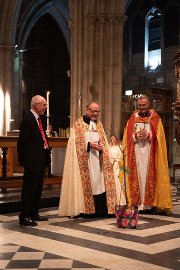 Mike Elden, Rob Jones and Bishop John standing behind a cherry tree