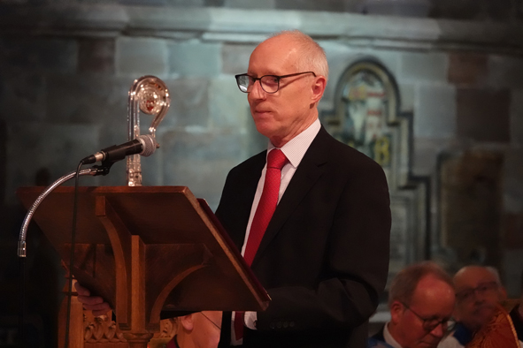 Mike Elden standing at the lectern in the cathedral ready to read the lesson
