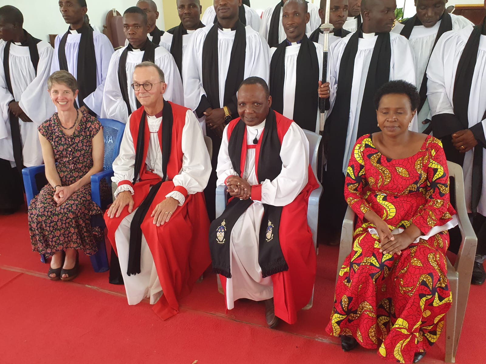 Bishop John & Bishop Godfrey with their wives in front of other clergy