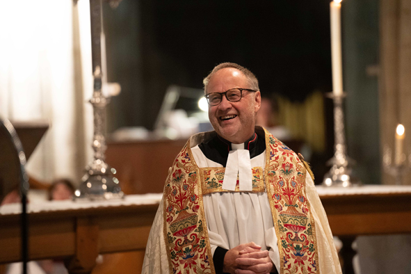 Robert Jones smiling in front of the altar at the cathedral