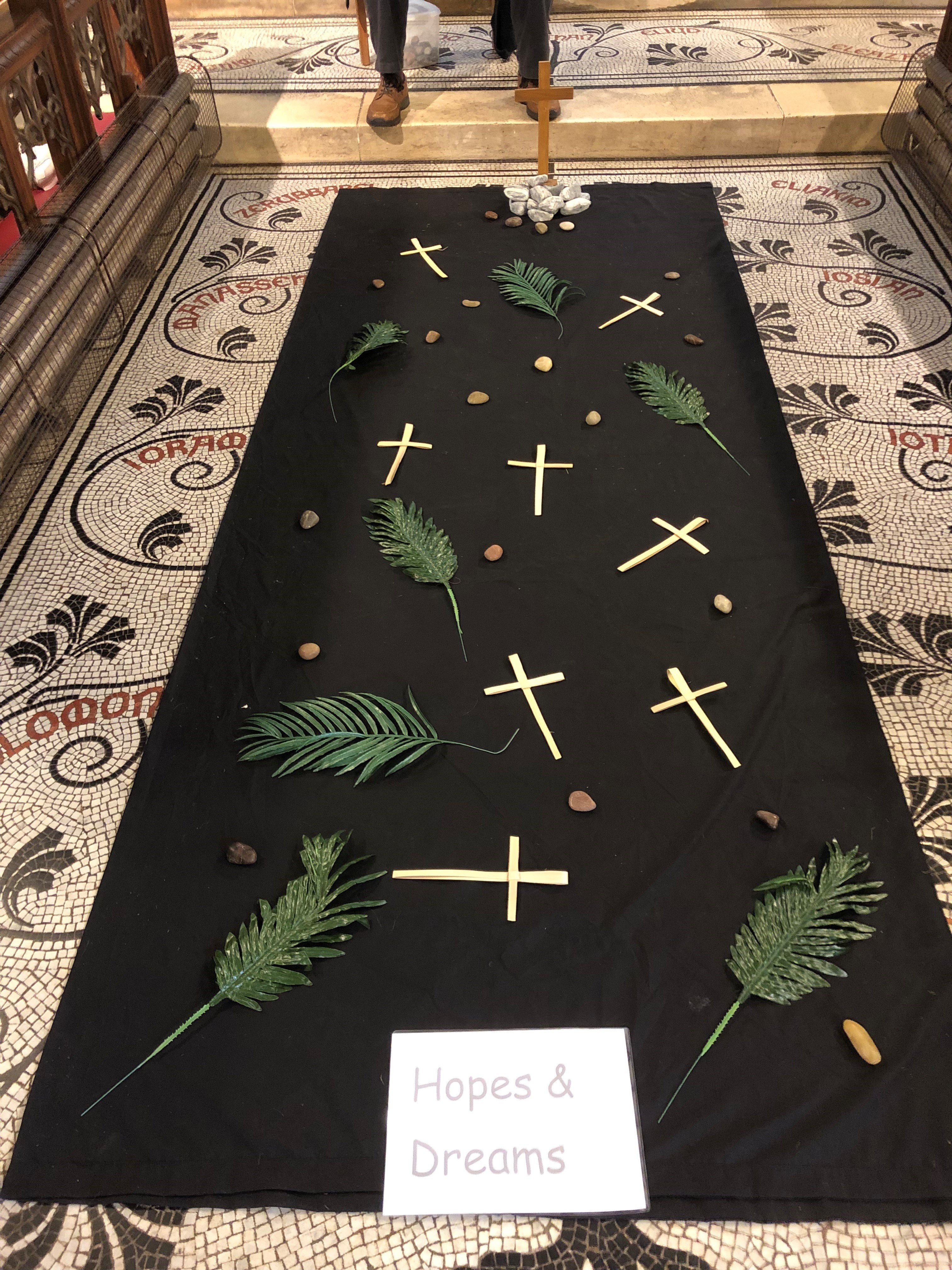 palms and crosses laid out on the floor to represent Palm Sunday