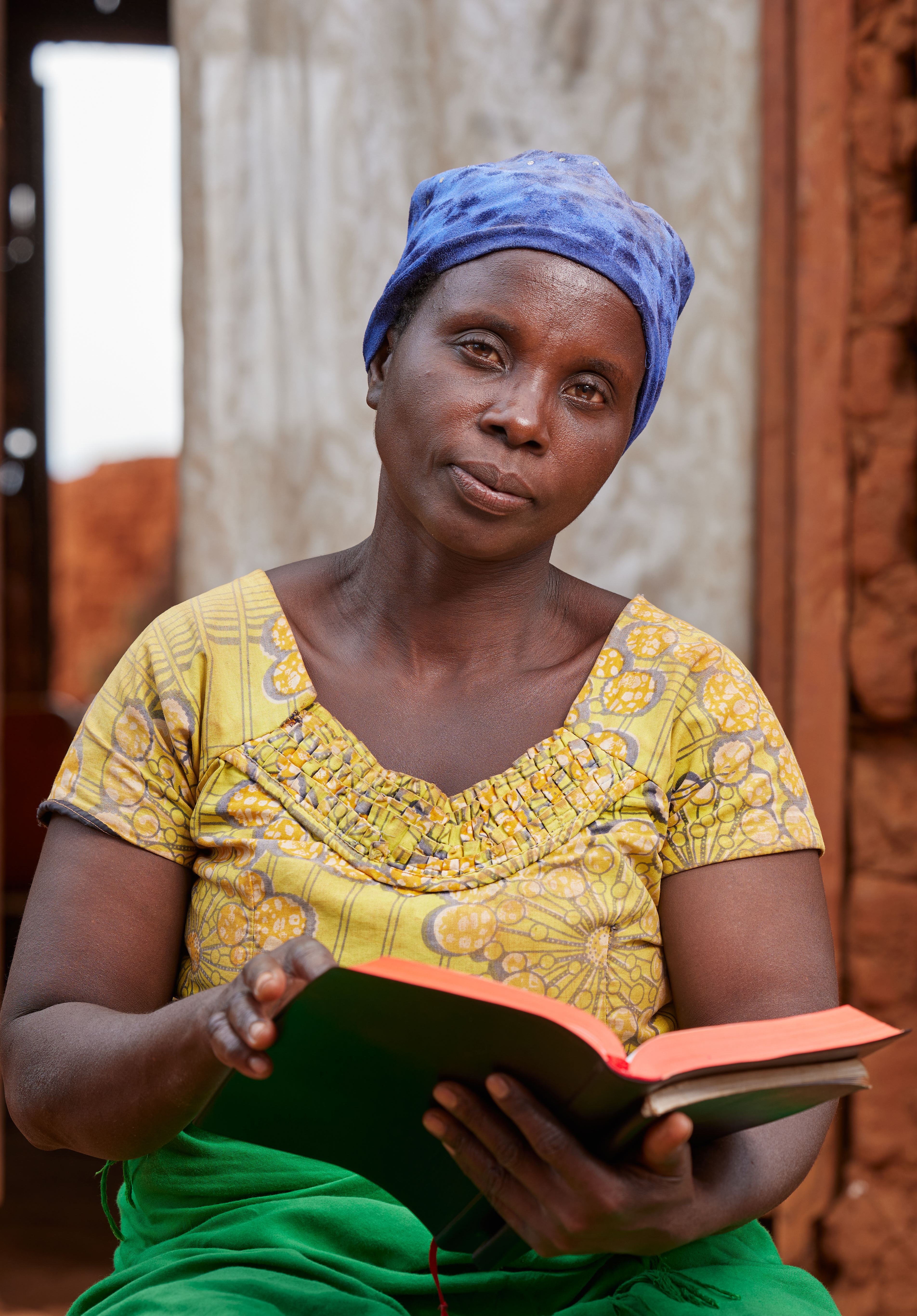 Aline Nibogora sitting reading a book