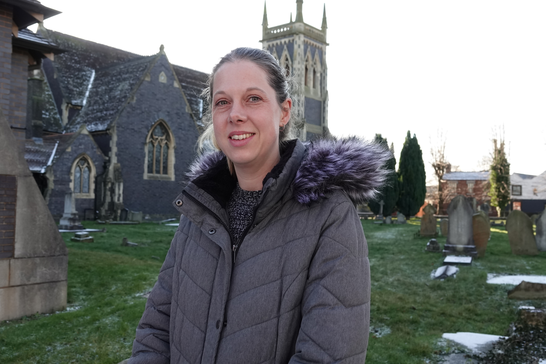 Keri Robinson standing outside St James' Church in Wollaston, Stourbridge