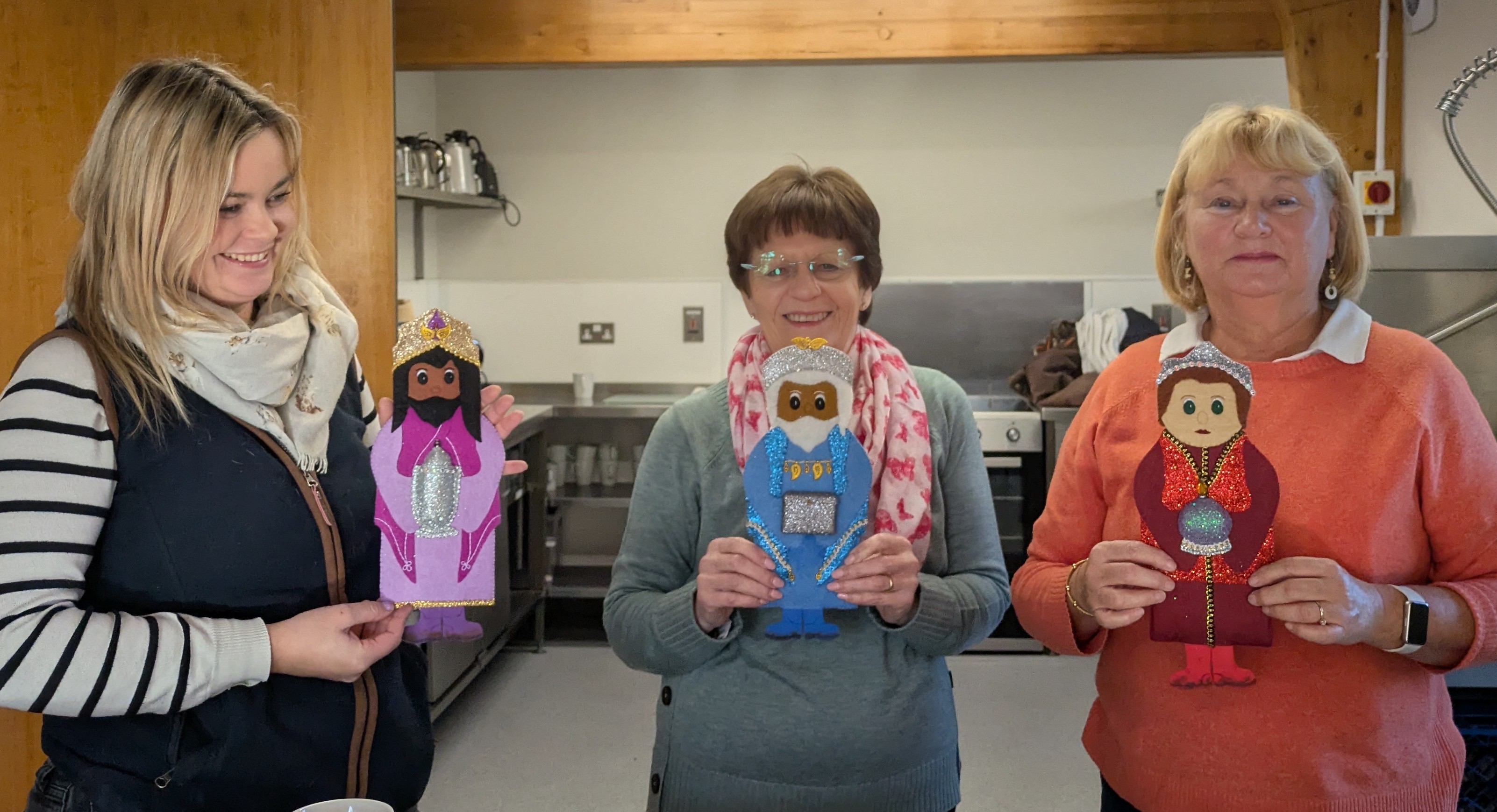 Three people holding the magi characters