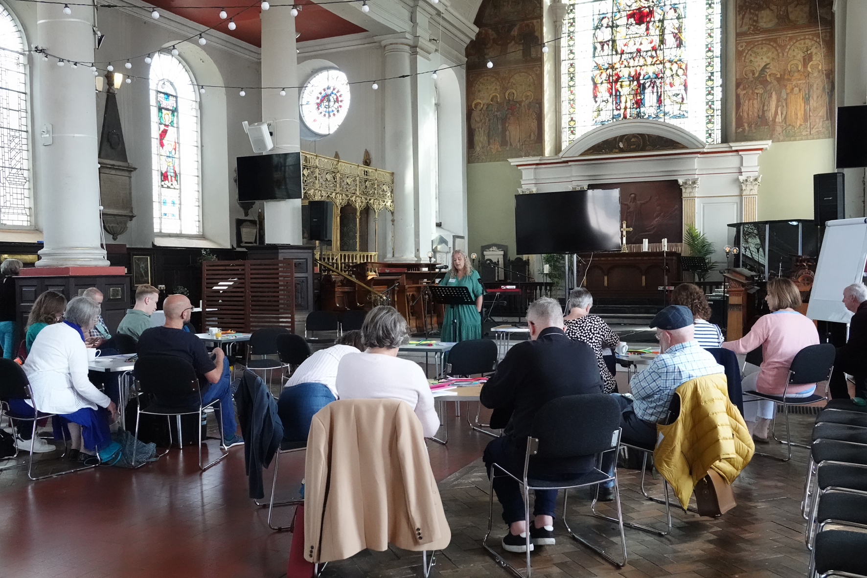 Mission Accompaniers sitting in groups in All Saints church