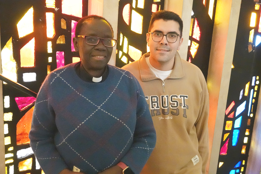Jacqueline Shalloe and Joseph Diwakar standing in front of a stained glass window