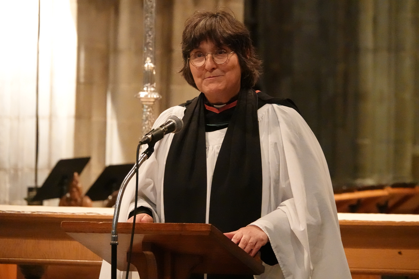 Sarah Brown standing a lectern at the front of the cathedral