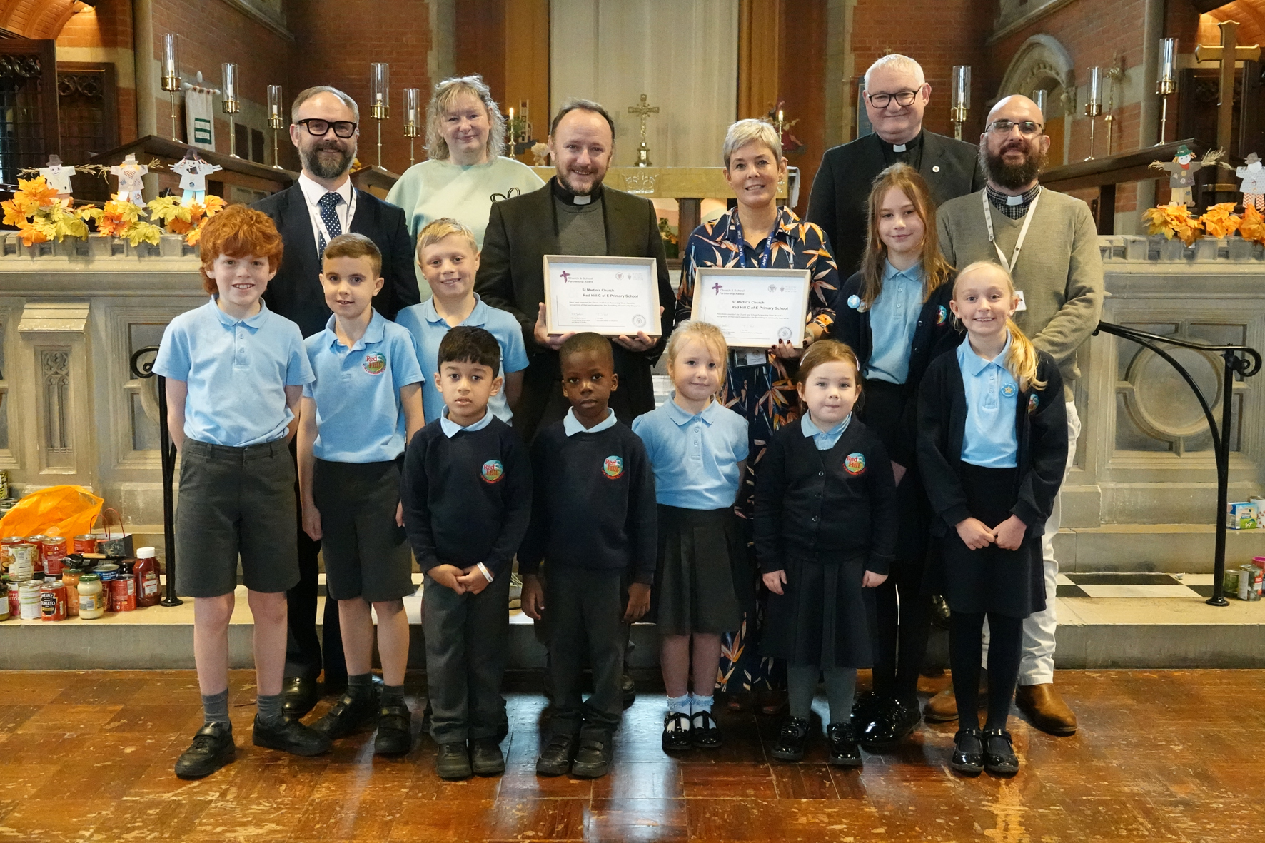 Children and staff from Red Hill School and members of St Martin's Church along with the diocesan education team and Mark Badger with their silver church & school partnership award certificates