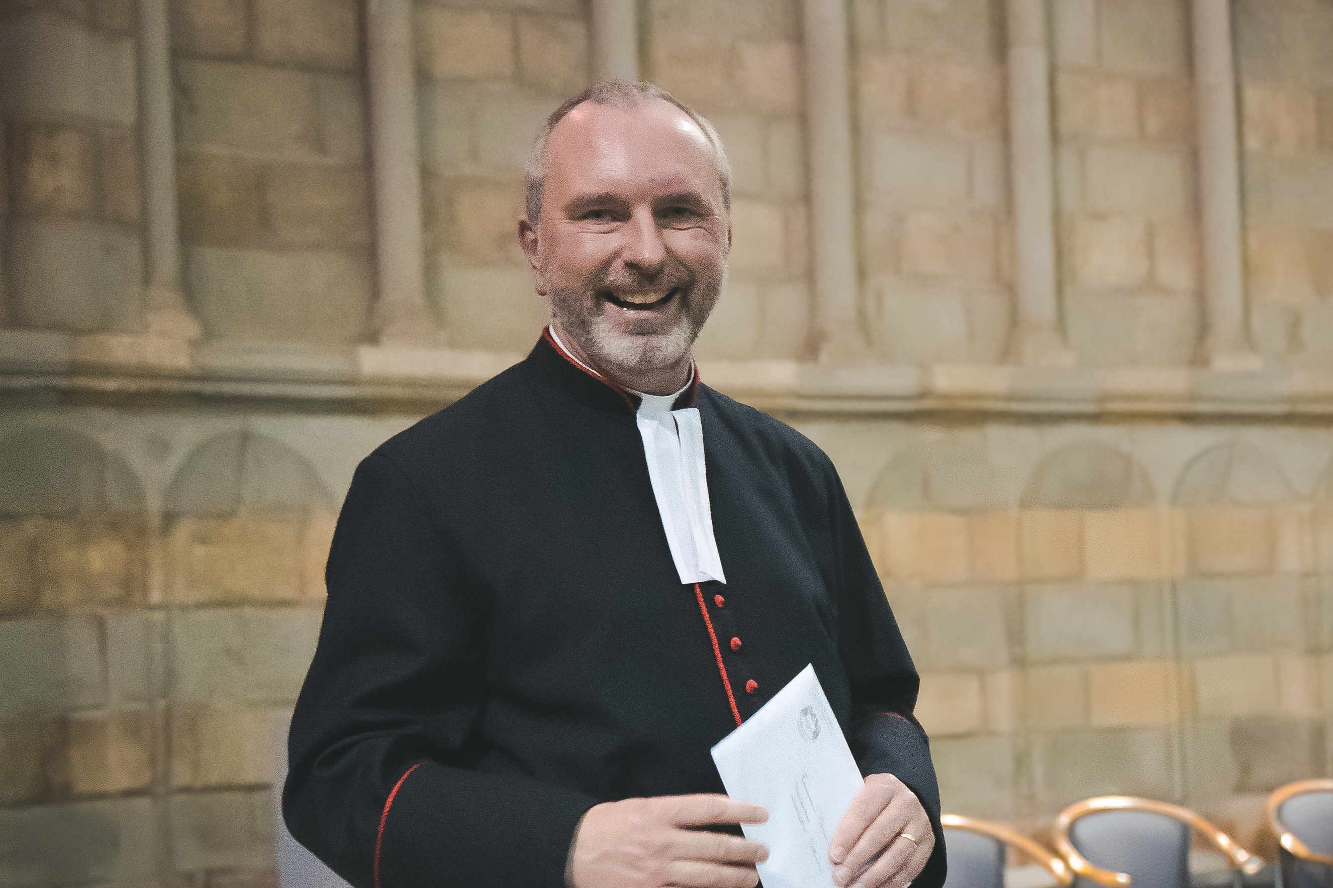 Canon John Paul Hoskins standing in the Chapter House