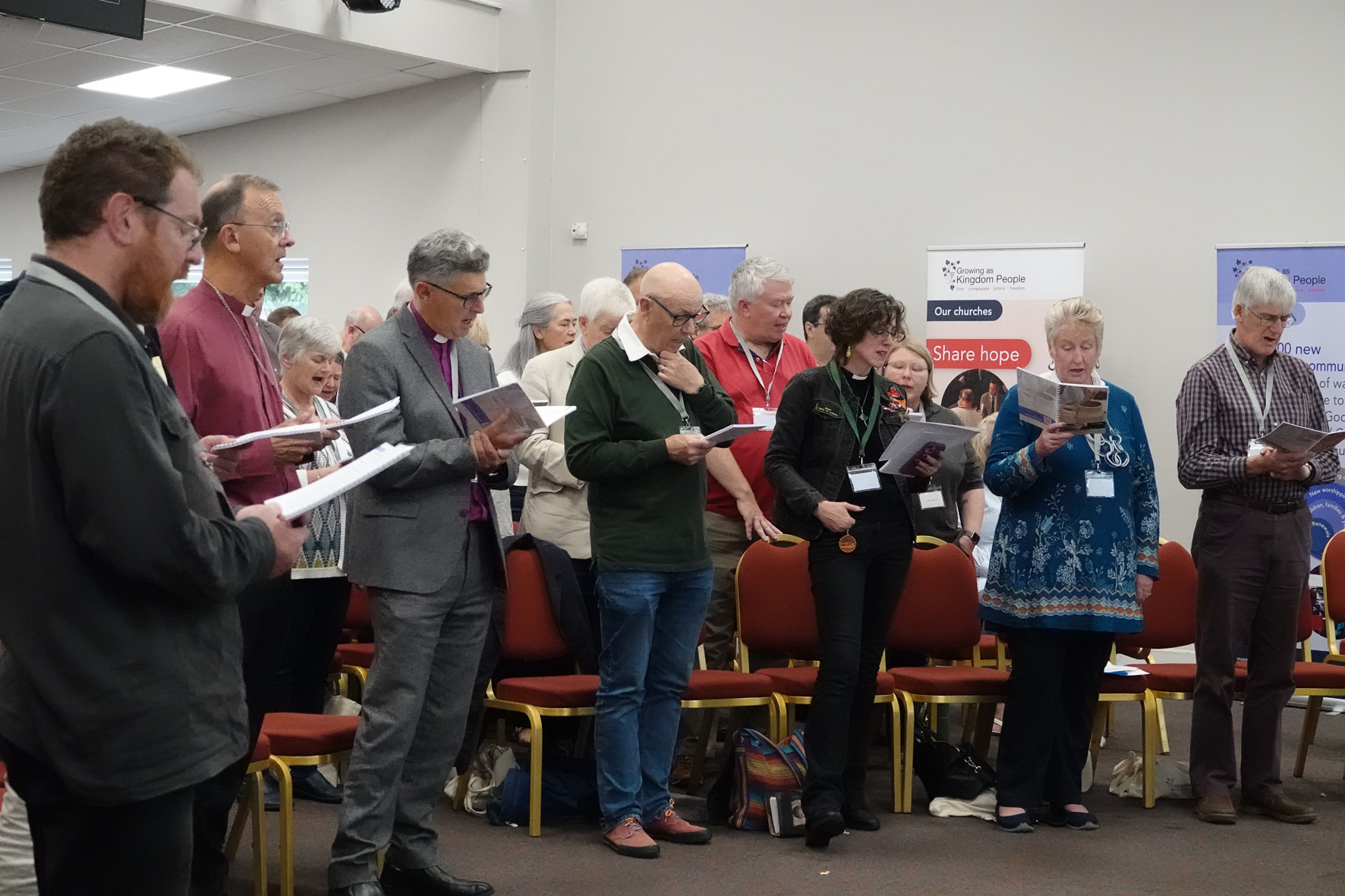 Members of the clergy at the front of a worship session at clergy conference