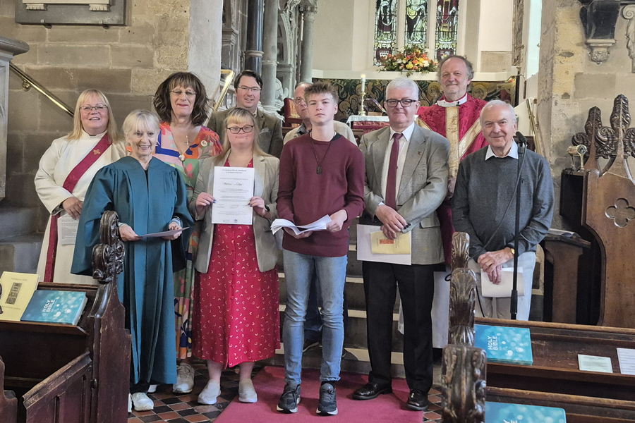 A group of new Chalice assistants standing at the front of St Laurence Alvechurch with the vicar and curate