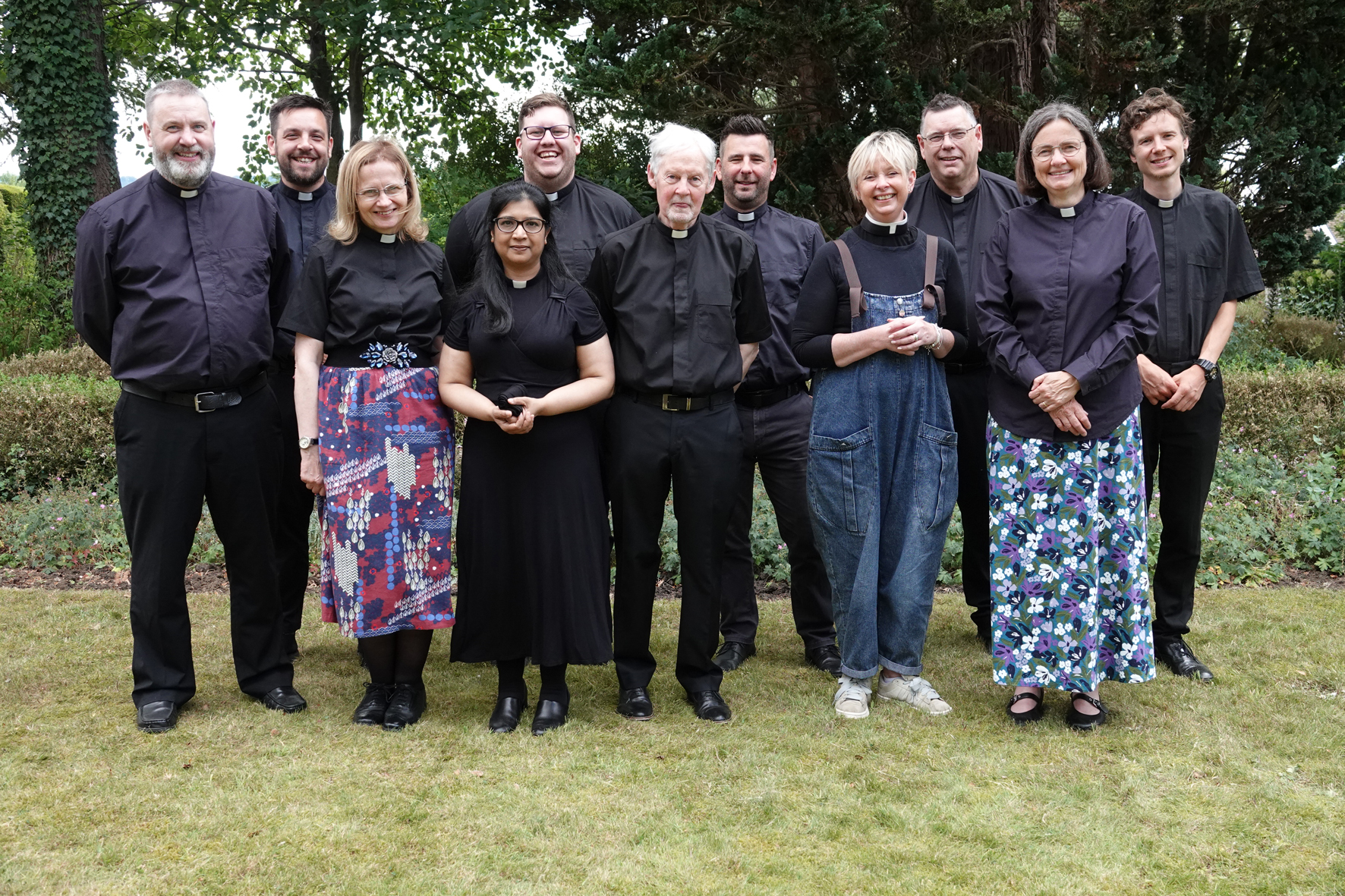 11 ordinands stood together in the grounds of Holland House
