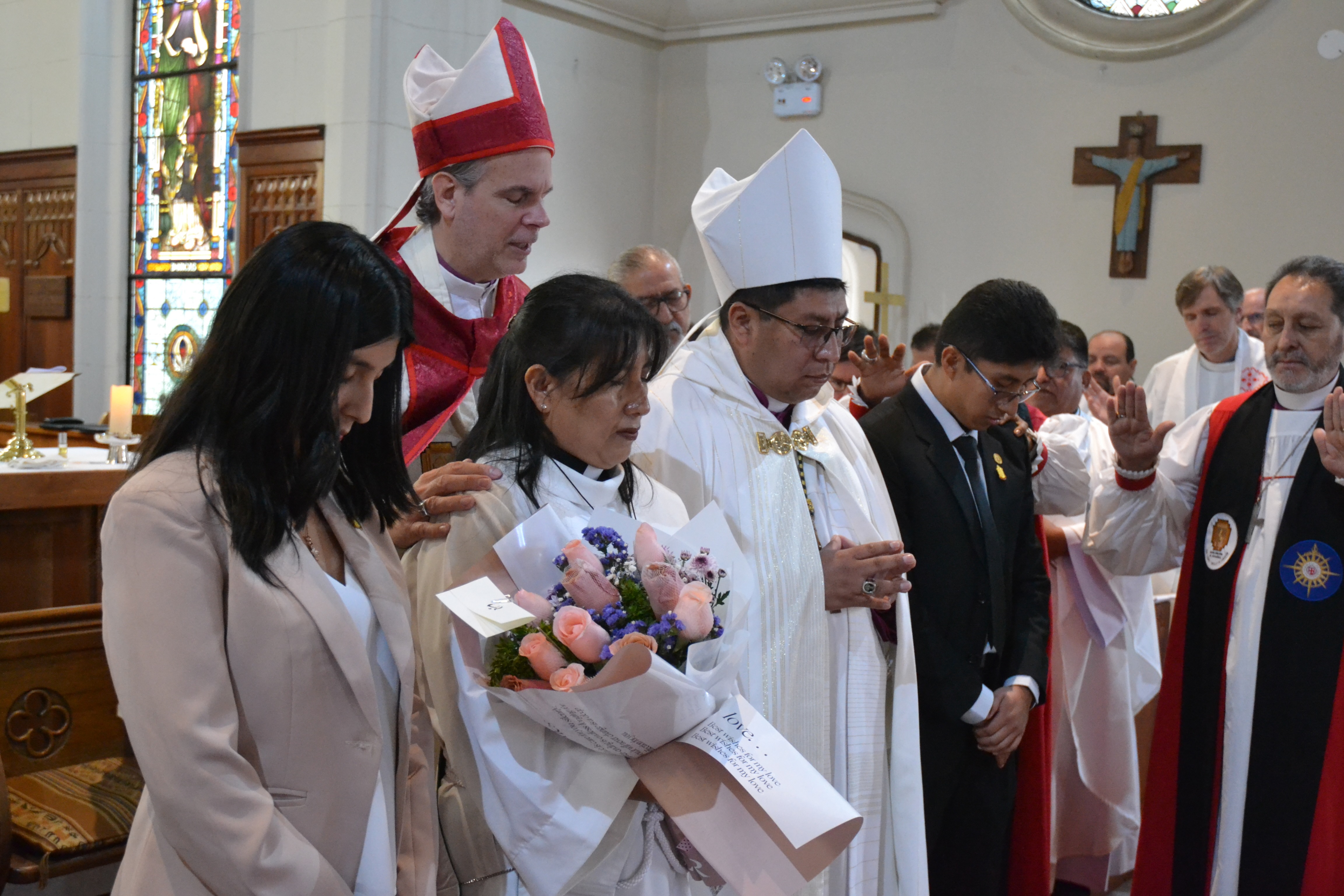 Bishop Victor with his family standing being prayed for by the Bishop of Argentina and South America