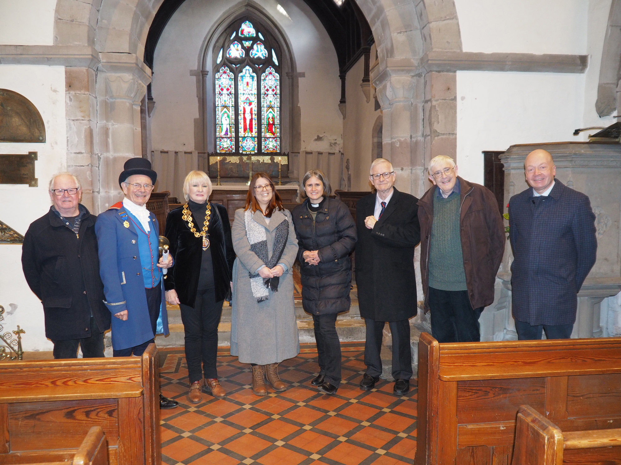 Line of of people present at the plaque unveiling