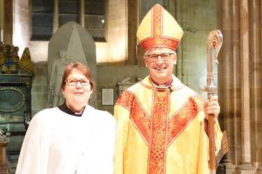 Sue Haywood standing next to Bishop Martin in the Cathedral