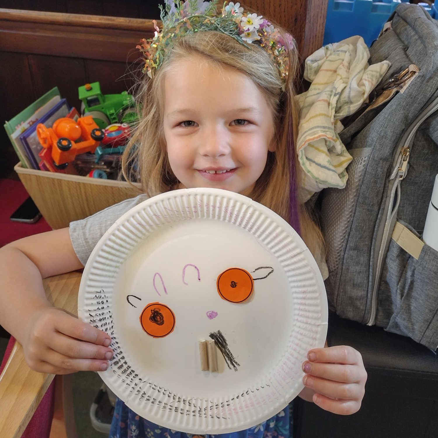Little girl holds up Gruffalo creation