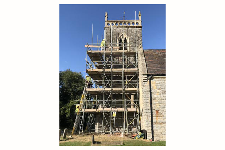 Church tower surrounded in scaffolding