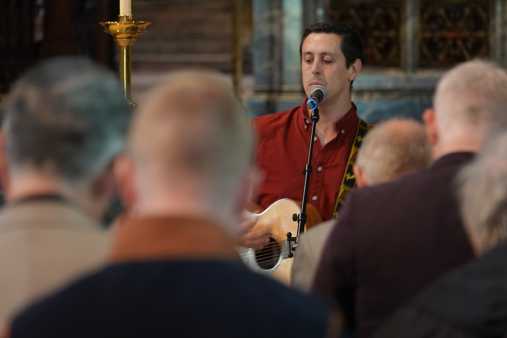 David Shaw with his guitar leading a congregation