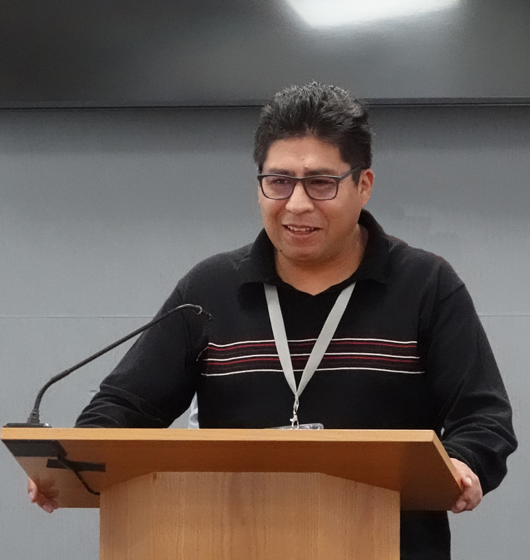 Victor Condori standing at a podium